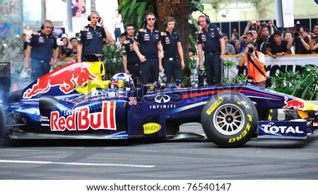 SINGAPORE - APRIL 24: David Coulthard performing donuts in the Red Bull Racing F1 car RB6 during Red Bull Speed Street Singapore on April 24, 2011 in Singapore.