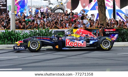 SINGAPORE - APRIL 24: David Coulthard driving the Red Bull Racing F1 car RB6 to perform stunts during Red Bull Speed Street Singapore on April 24, 2011 in Singapore.