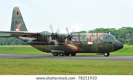 SINGAPORE - MAY 28: Republic of Singapore Air Force (RSAF) C-130 Hercules military cargo plane taxies during RSAF Open House 2011 on May 28, 2011 in Singapore.