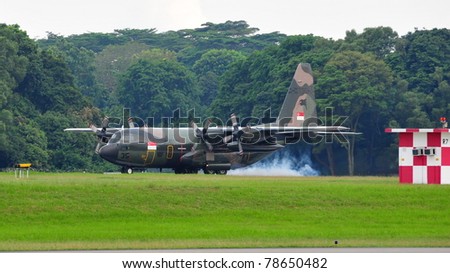 SINGAPORE - MAY 28: Republic of Singapore Air Force (RSAF) C-130 Hercules military cargo plane landing during RSAF Open House 2011 on May 28, 2011 in Singapore.
