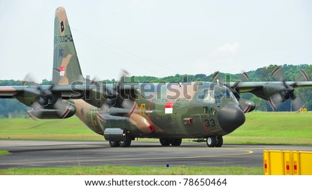SINGAPORE - MAY 28: Republic of Singapore Air Force (RSAF) C-130 Hercules military cargo plane taking off during RSAF Open House 2011 on May 28, 2011 in Singapore.