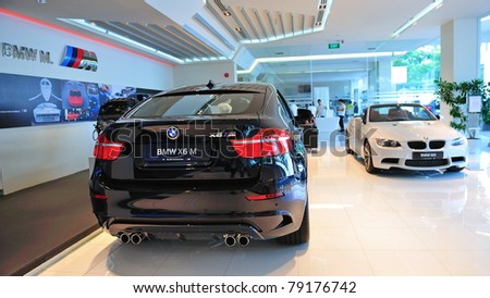 SINGAPORE - MAY 21: Static display of BMW X6 M and M3 cabriolet at Munich Automobiles BMW Service Centre Open House on May 21, 2011 in Singapore