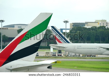 SINGAPORE - JANUARY 10: Tails of Air France Boeing 777-300ER and Emirates Boeing 777-300ER at Changi Airport on January 10, 2015 in Singapore