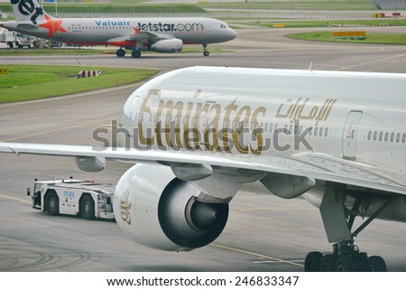 SINGAPORE - JANUARY 10: Emirates Boeing 777-300ER being pushed back at Changi Airport on January 10, 2015 in Singapore