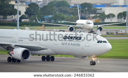 SINGAPORE - JANUARY 10: Qantas Airbus 330 taxiing to gate at Changi Airport on January 10, 2015 in Singapore