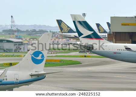 SINGAPORE - JANUARY 10:  Tails of Cathay Pacific Airbus 330 and Xiamen Airlines Boeing 737-800 at Changi Airport on January 10, 2015 in Singapore
