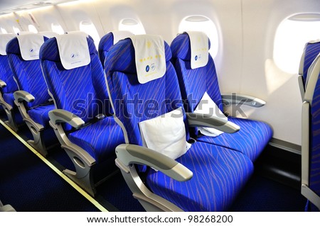 SINGAPORE - FEBRUARY 17: Economy class cabin in China Southern Airlines Embraer 190 aircraft at Singapore Airshow February 17, 2012 in Singapore