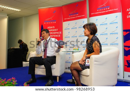 SINGAPORE - FEBRUARY 17: Mr Jimmy Lau (Managing Director of Experia Events) and Ms Angelica Lim (General Manager) speaking at the media briefing at Singapore Airshow February 17, 2012 in Singapore