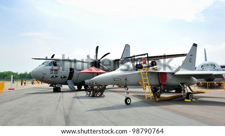 SINGAPORE - FEBRUARY 17: Italian Air Force C-27J Spartan cargo aircraft and T-347A training aircraft on display at Singapore Airshow February 17, 2012 in Singapore