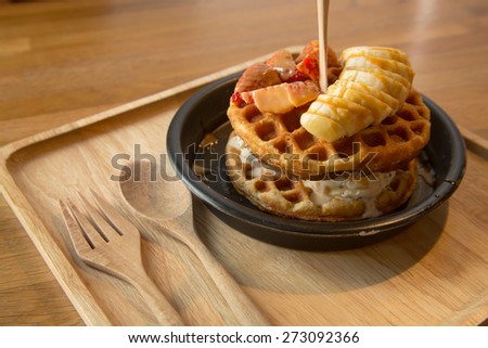 Home made style whole wheat waffle with cookie and cream ice cream, strawberries, bananas and caramel topping