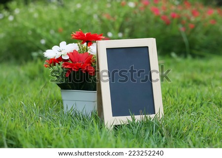 empty Wooden black board (menu board) in Flower Garden