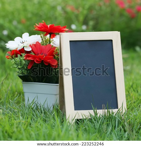 empty Wooden black board (menu board) in Flower Garden