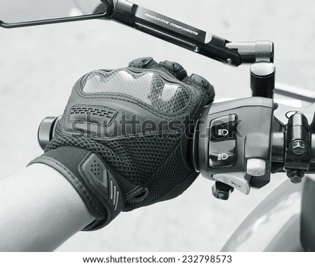 Human hand in a Motorcycle Racing Gloves Ready to ride ( black white )