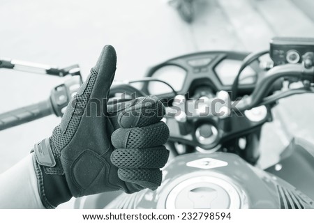 Human hand in a Motorcycle Racing Gloves Ready to ride ( black white )