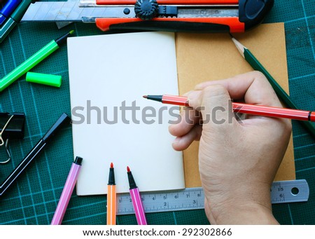 Hand write on the notebook and office accessories on green Pads