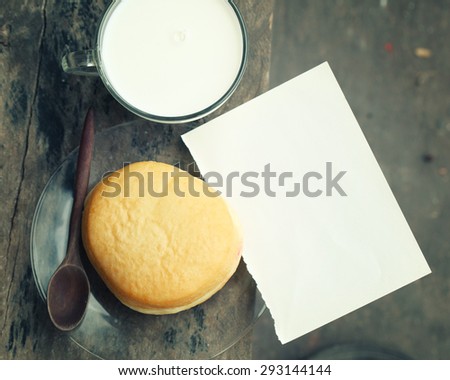 empty paper note  with a cup of fresh milk on old wooden table.Vintage Style