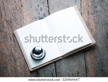 notebook with service bell on antique wood background.