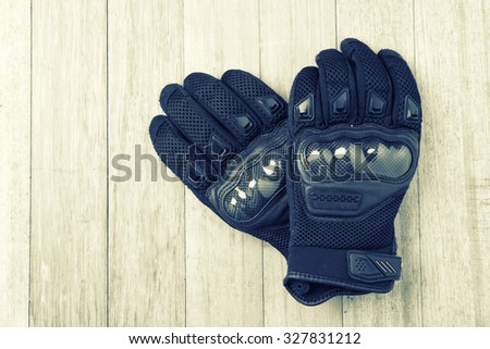 Motorcycle gloves on wooden ,diet concept-vintage effect.