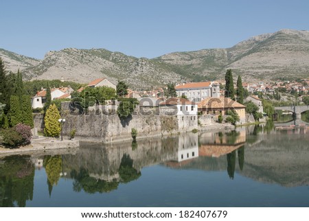 Mirror image of the old buildings in the town of Trebinje, Bosnia and Herzegovina in the water of the river, landscape photo