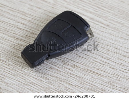 electronic car key on the wooden table, close up photo