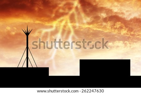 silhouette lightning rod. orange sky background
