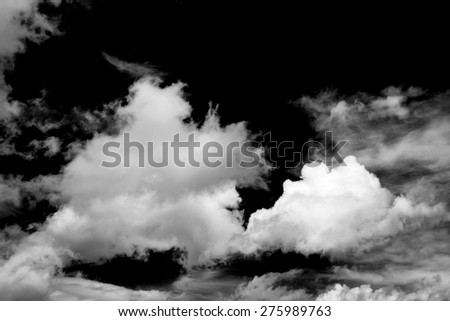 Black and White fluffy clouds in the blue sky