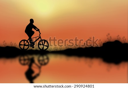 Children and bike silhouette on the surface. Sunset background