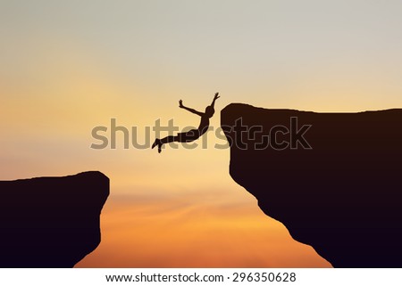 Silhouette man jump over the cliff
