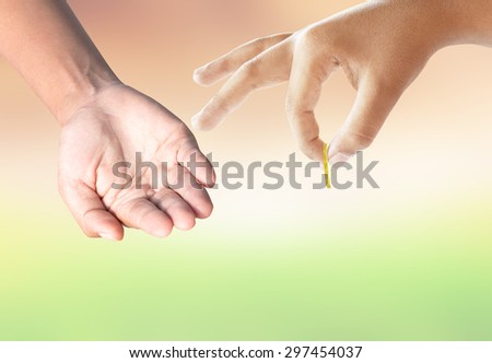 hand gives money to the poor.