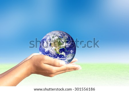 We love the world of ideas.world  in human hands. Natural background blur. Elements of this image furnished by NASA.