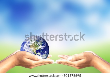 We love the world of ideas,Hand give world on nature background.Elements of this image furnished by NASA.