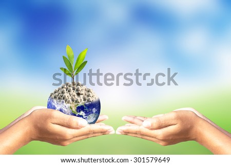 We love the world of ideas,Hand give world and tree on nature background.Elements of this image furnished by NASA.