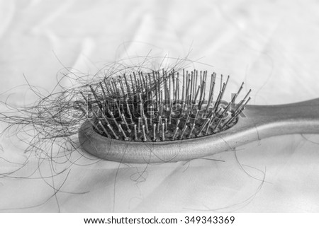 comb brush with lost hair on white cloth