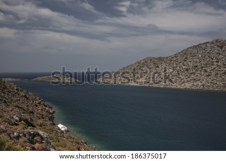 A chapel on the edge of some rocks, in a bay located in Karpathos island, Greece.
