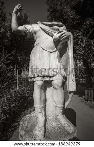 Statue without head, located in a park, in Rome, Italy.