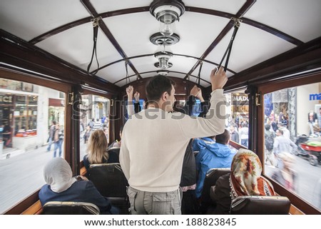 ISTANBUL, TURKEY - MAY 18, 2011: People, in a tram, transfer through it all around the city, in order to go to their work, during a busy day. Public transportation is the most popular way to transfer.