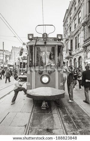 ISTANBUL, TURKEY - MAY 18, 2011: People get on board, in a tram, during a busy day, from both sides of it, in order to transfer around the city and go to their jobs.