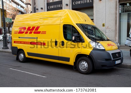 VALENCIA, SPAIN - JANUARY 28, 2014: A DHL delivery van on the street in the city center of Valencia. DHL is a world wide courier company that operates in 220 countries with over 285,000 employees.