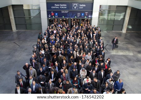 VALENCIA, SPAIN - FEBRUARY 12, 2014: A crowd of business people waiting to enter the 2014 Feria Habitat Valencia Trade Fair in Valencia.