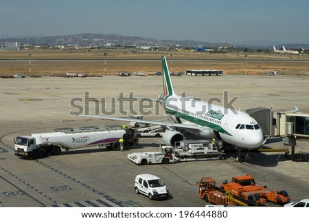 VALENCIA, SPAIN - JUNE 3, 2014: An Alitalia aircraft at the gate at the Valencia airport. Alitalia is the flag carrier and national airline of Italy and one of the biggest airlines in Europe.