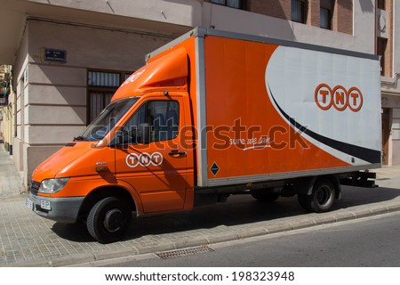 VALENCIA, SPAIN - JUNE 10, 2014: A TNT Express truck in Valencia. TNT Express is an international courier delivery services company with sales of over 6.69 billion euros in 2013.