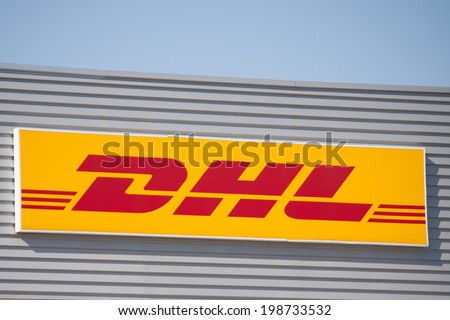 VALENCIA, SPAIN - JUNE 15, 2014: A DHL company sign at its depot in Valencia. DHL is a world wide courier company that operates in 220 countries with over 285,000 employees.