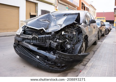 VALENCIA, SPAIN - AUGUST 4, 2014: A crash car parked on the street in Valencia waiting for repair. A 1985 study by K. Rumar, found that 57% of car crashes were due solely to driver error.