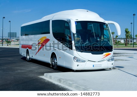 White tour bus in parking lot
