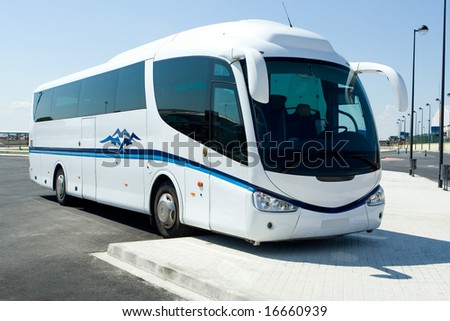 White tour bus in parking lot