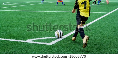 Young soccer player in a corner kick