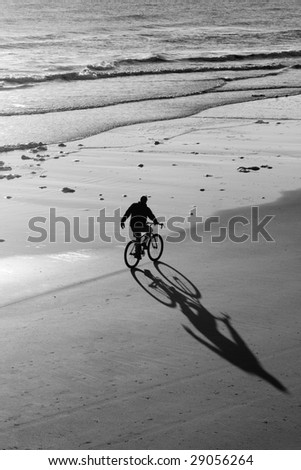 Lone Bike Rider on the Beach in Black and White
