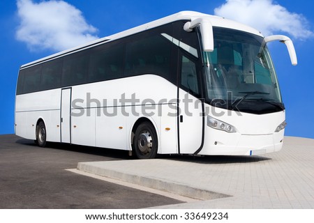 A Big White Tour Bus with Blue Skies