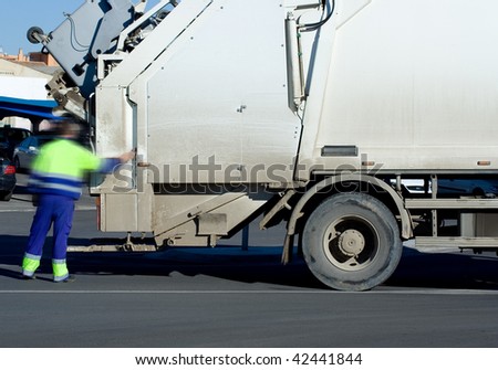 A White Garbage Truck with male worker