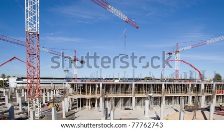 Construction site with cranes and blue skies